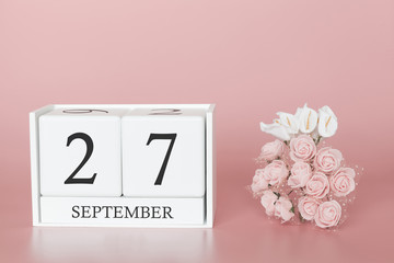 September 27th. Day 27 of month. Calendar cube on modern pink background, concept of bussines and an importent event.
