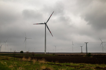 Wind generator turbine or windmill or wind farm, cloudy foggy day