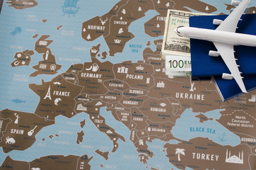 Airplane model, two passports and money. Travel concept on Europe map background.