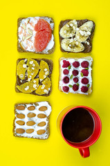 Healthy breakfast toasts with peanut butter, banana, chocolate, chia seeds, raspberries, almond, yogurt, oranges, grapefruit. Color background