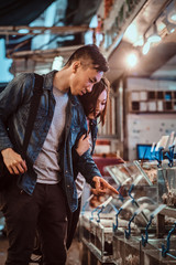 Asian couple fing something exaiting at market.