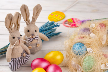 Toy bunny and colorful Easter eggs as a festive background composition