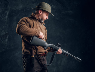 Opening of the spring hunting season. A man cleans rifle barrel