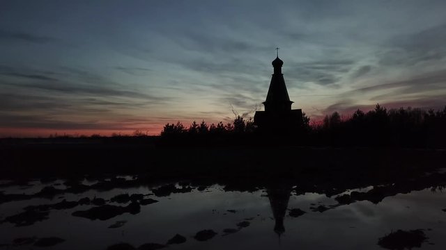 Silhouette of the temple in the name of the Icon of the Mother of God The Bogger of the microdistrict of the Lugovaya town of Lobnya, Moscow region. Sunset landscape