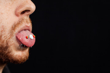 Bearded Man with white Pill on Tongue