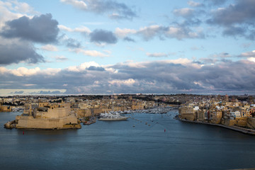 Obraz premium Valletta panoramic view, town fortress walls and ships in the sunset lights. Malta island. 