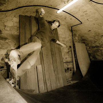 Young Man on Skateboard in a Half-Pipe