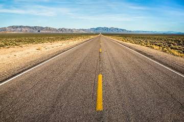 Fototapeta na wymiar Dotted line down long, straight, Extraterrestrial Highway of the Nevada Desert