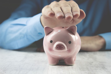 man holding a piggy bank