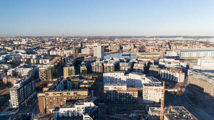 Construction site background. Hoisting cranes and new multi-storey buildings at sunset. Industrial background. Jatkasaari, Helsinki,Finland