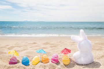 Beach Easter background with bunny and color eggs - 262348580