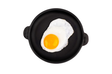 Fried egg on frying pan, top view. Isolated on white background.