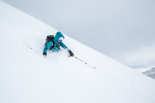 Telemark skier in deep soft powder in Northern Japan. Backcountry skiing near Niseko Mountain.