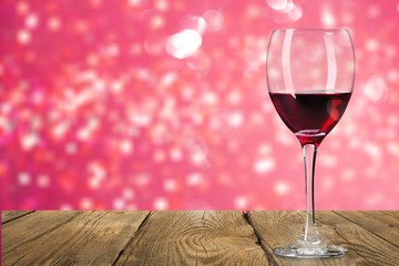 Red wine glass on wooden desk