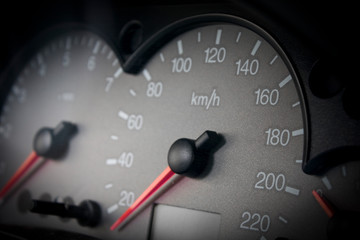 Close up picture of a car dashboard with speedometer showing speed in Km/h
