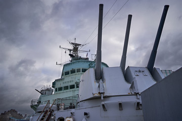 Front main gun turret with tree big guns and with captain bridge behing in the british cruiser HMS...