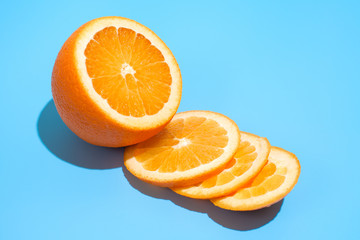 Ripe juicy delicious orange on blue background. Healthy eating and dieting concept