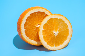 Ripe juicy delicious orange on blue background. Healthy eating and dieting concept