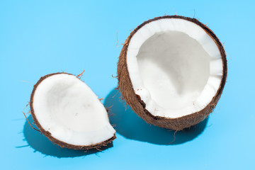 Fresh juicy coconut isolated on a blue background. Concept of Healthy eating and dieting. Travel and holiday concept