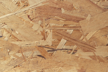 Pressed and glued wood chips. Plywood board Abstract background. Texture of plywood from large wood chips.