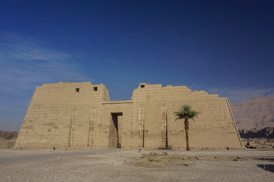 Luxor, Egypt: The first pylon of Medinet Habu, New Kingdom mortuary temple of Ramesses III on the West Bank of the Nile River.
