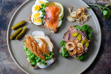 Scandinavian open sandwiches: beef, watercress and crisp onion, egg and salmon, smocked mackerel with crushed peas, fennel and apple