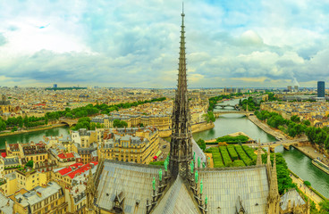 Detail of the spire of Notre Dame cathedral with statues, in Paris city capital of France. From top of the gothic church Our Lady of Paris, aerial view on Paris skyline.