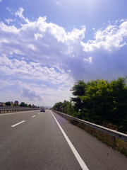 Empty asphalt road to the background blue sky