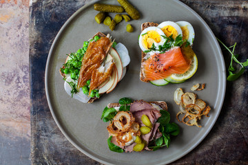 Scandinavian open sandwiches: beef, watercress and crisp onion, egg and salmon, smocked mackerel with crushed peas, fennel and apple