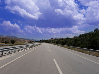 Fototapeta premium Empty asphalt road to the background blue sky
