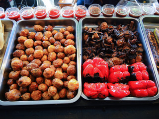 Assortment of grilled vegetables, red paprika, potatoes and mushrooms, street food. 