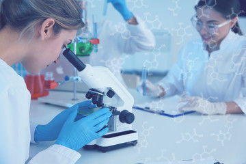 Medical student working with microscope in modern scientific laboratory, color tone
