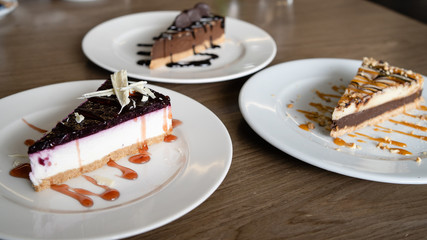 Close up on cake slices in plates on the table at the hotel restaurant