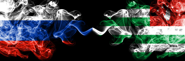Russian vs Abkhazia, Abkhazian smoke flags placed side by side. Thick colored silky smoke flags of Russia and Abkhazia, Abkhazian