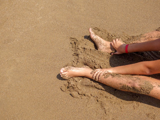 Playing with sand on the beach