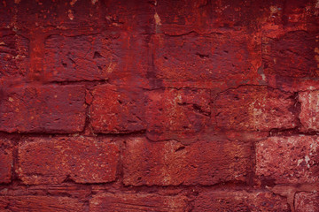 Old grungy brick wall. Free space for an inscription. Can be used as a background or poster. Fragment of a wall with bumps and peeling paint.