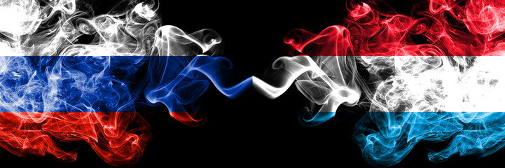 Russian vs Luxembourg smoke flags placed side by side. Thick colored silky smoke flags of Russia and Luxembourg