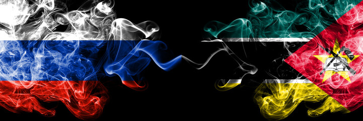 Russian vs Mozambique, Mozambican smoke flags placed side by side. Thick colored silky smoke flags of Russia and Mozambique, Mozambican