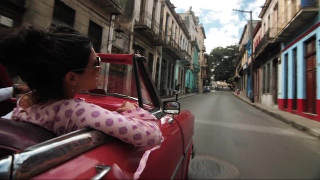 Woman Riding in Vintage Car in Havana Cuba, Driving down the streets of Havana