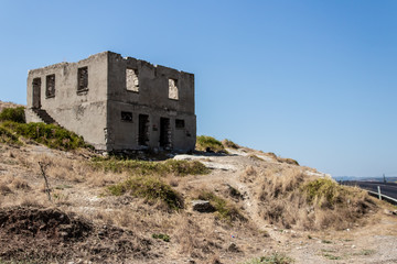Fototapeta na wymiar an antique stone building at a hill of mountain