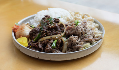 Hawaiian lunch plate with pork, beef, rice and vegetables served on a plate