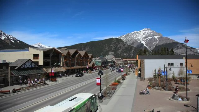 Time lapse of Banff Avenue with Cascade Mountain and Canadian Flags, Summer Day, Banff Alberta Canada