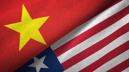 Vietnam and Liberia two flags textile cloth, fabric texture