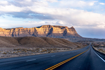 Direct divided highway road in the vast Arizona with mountain and desert plateau