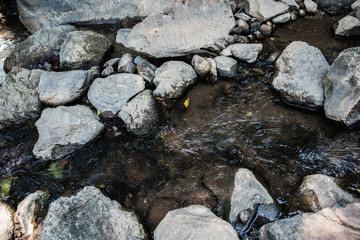 Waterfall in the nature and stone background