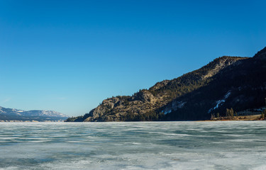 Fototapeta na wymiar early spring landscape of frozen Columbia Lake Regional District of East Kootenay Canada.