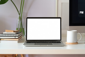 Mockup blank screen laptop on white workspace