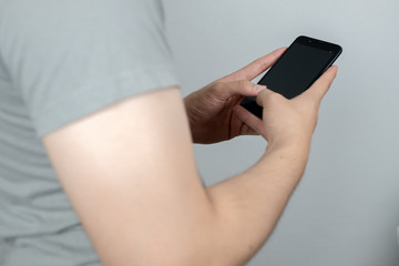 Man uses his Mobile Phone , close up