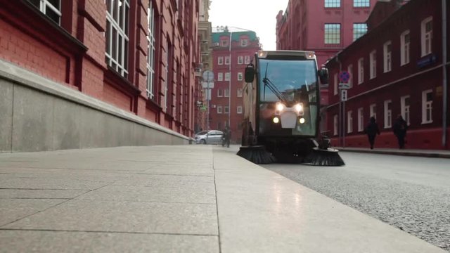 Two street sweeper going down the european street