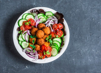 Sweet potato falafel vegetables salad bowl on dark background, top view. Vegetarian food concept